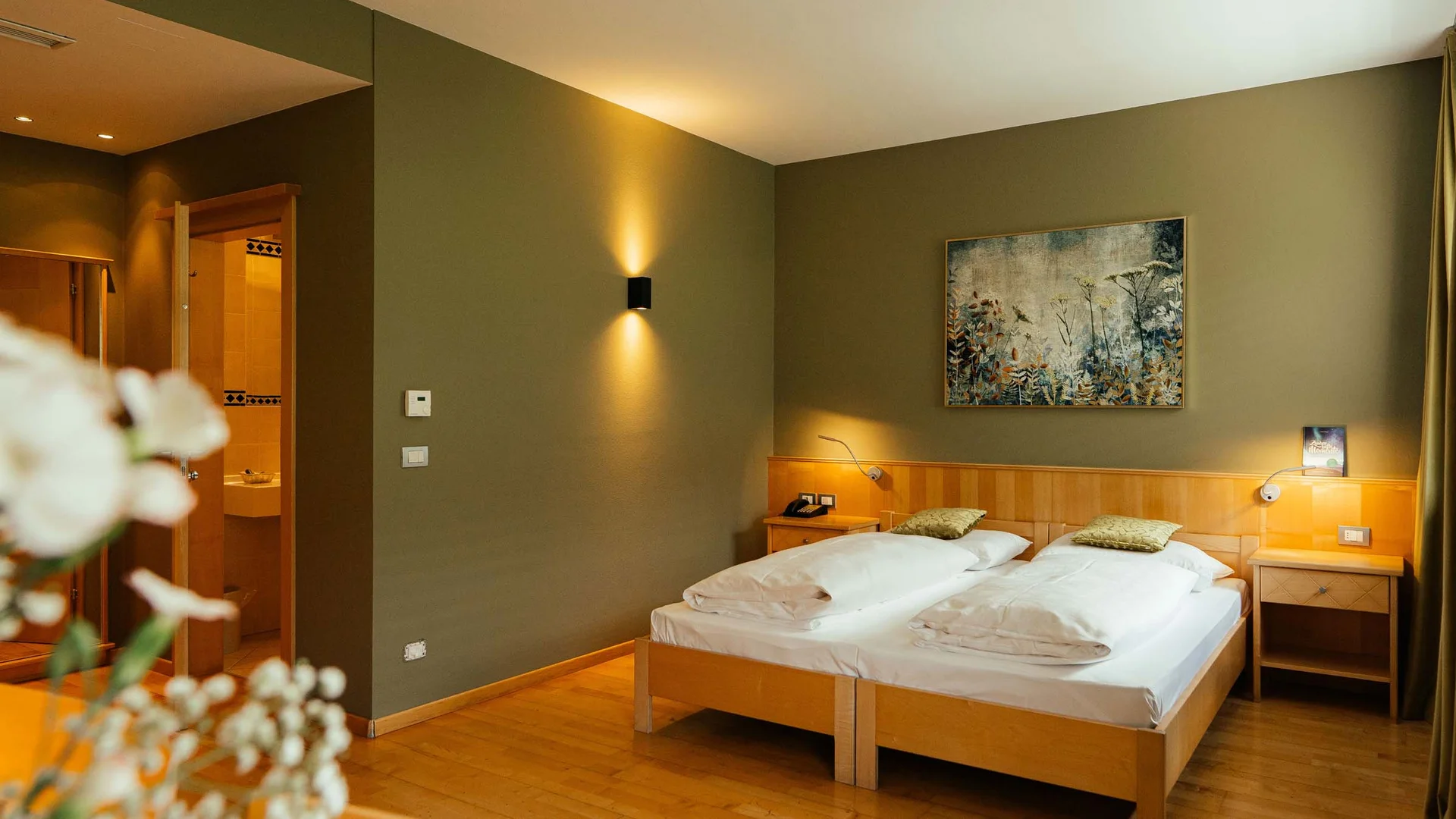 Cozy hotel room with two single beds and warm lighting