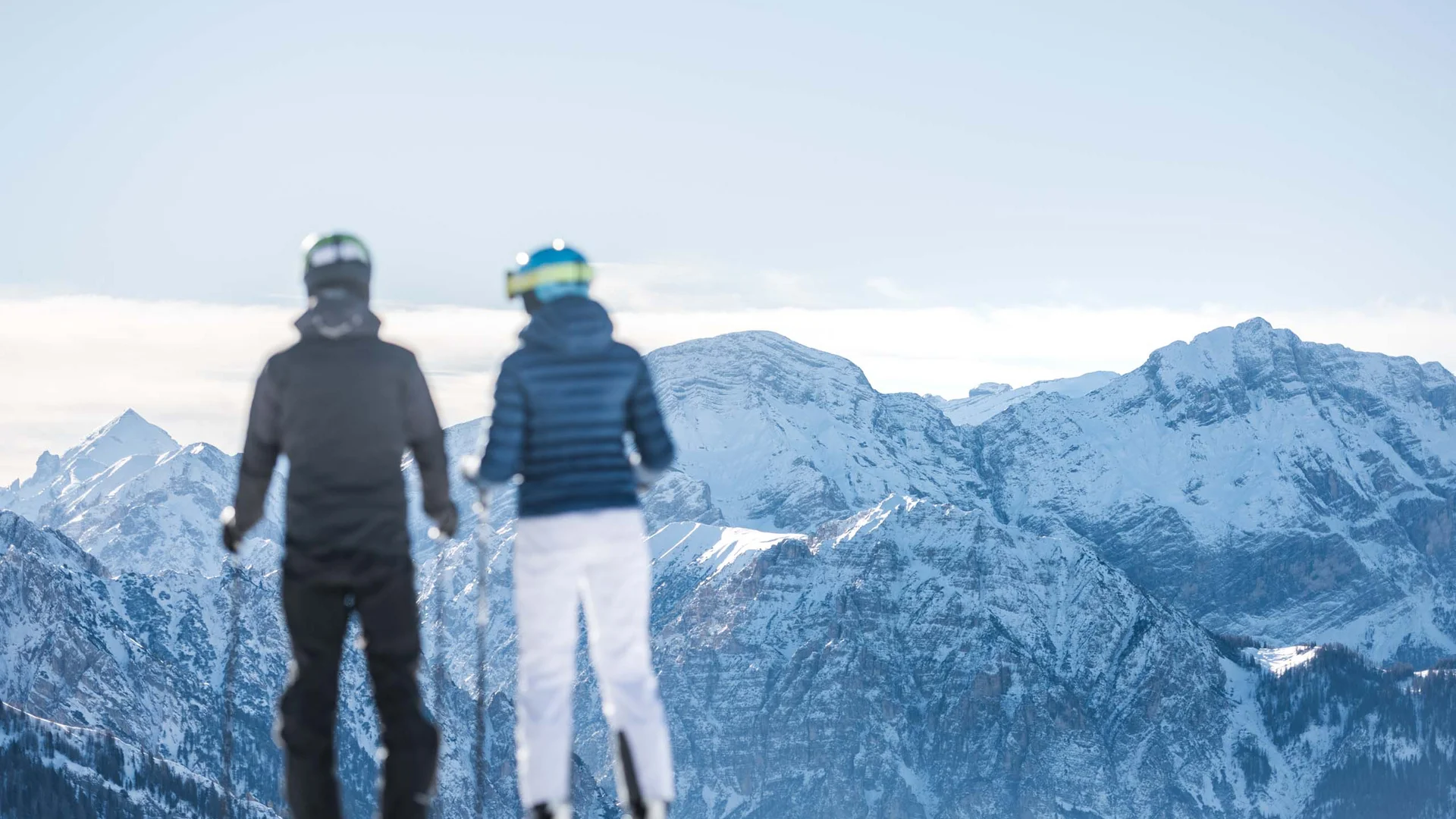 Hotel & Residence Lodenwirt photo gallery Two skiers looking at snow-covered mountain peaks