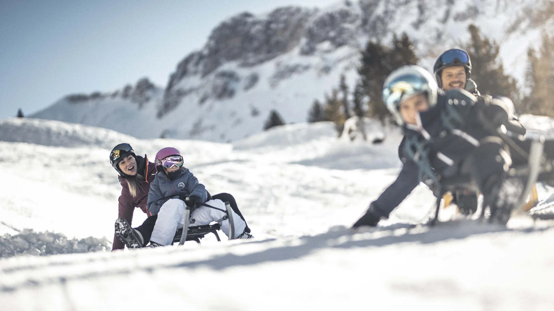 Hotel & Residence Lodenwirt photo gallery People ride together on a sled through a snowy mountain landscape