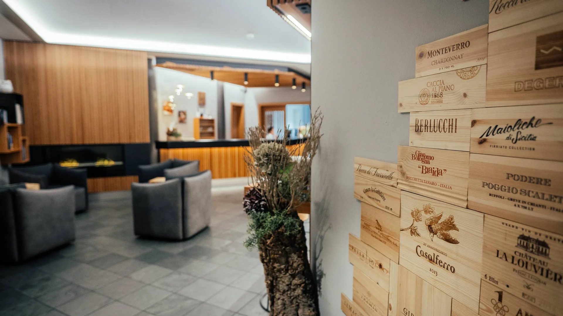 Moderne Hotellobby mit grauen Sesseln und Holzwanddekoration